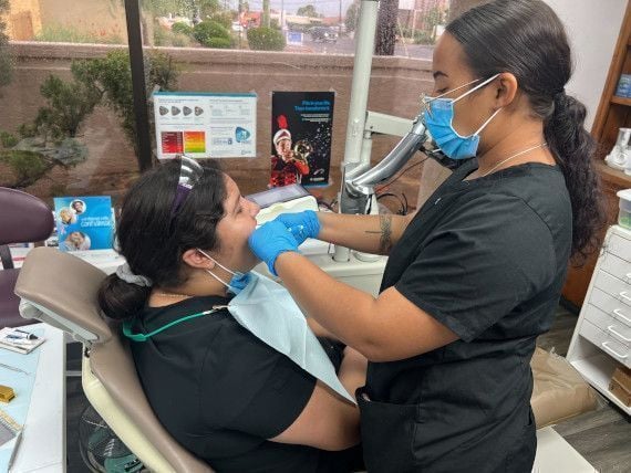 female dental assistant practicing how to treat patient