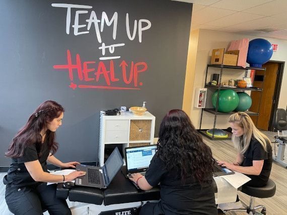 Aspiring medical assistants working on laptops