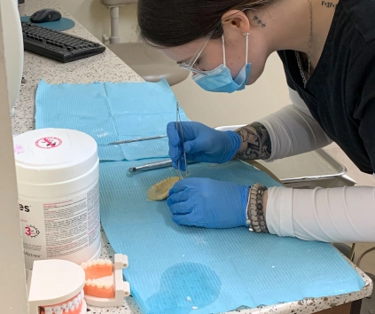 dental assistant student creating a dental impression