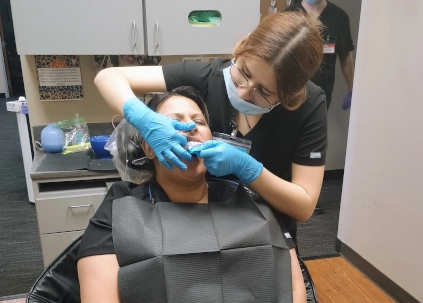 Dental Assistant student Rubi Baez practicing alginate impressions on fellow student Sarah Marachua at Denton DAS