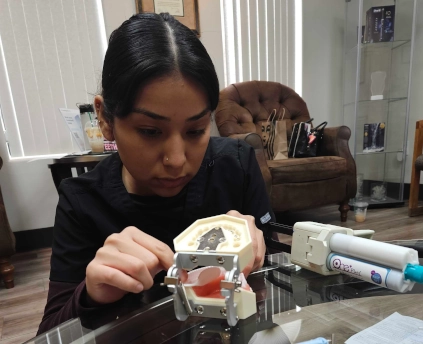  Dental Assistant student at Waco DAS fabricating a temporary crown during hands-on training 
