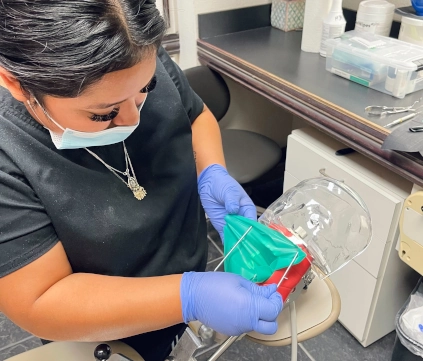 McKinney DAS student working on dental model trimming during hands-on training session