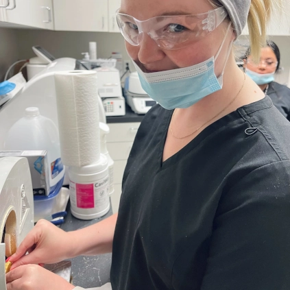  Dental assistant student at McKinney DAS placing a rubber dam as part of clinical skills lab 