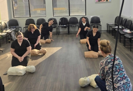  Dental Assistant students at Odessa DAS performing hands-on CPR practice on training dummies 