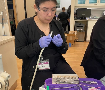  Focused student preparing dental material for crown fabrication at Pearland Dental Assistant School 