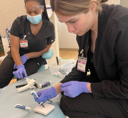  Pearland DAS AM class students working together on temporary crowns during hands-on lab 