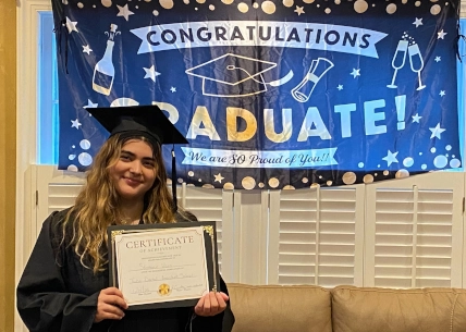 Confident graduate from Tulsa Dental Assistant School, celebrating successful program completion.