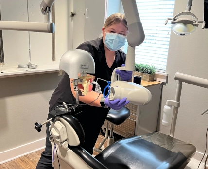 Waco DAS student positioning a training mannequin to take dental X-rays during week 7 of the program