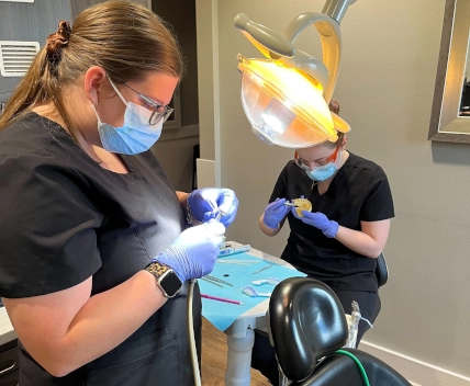  Close-up of student preparing material for a temporary crown in a Waco DAS clinical lab 