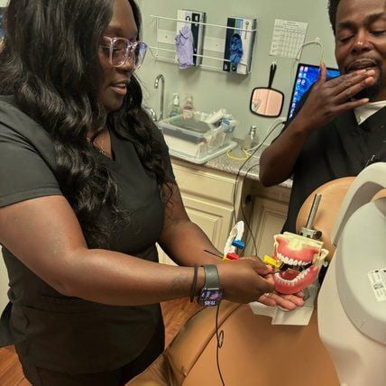 Dental Assistant in Tacoma dental office reviewing patient chart