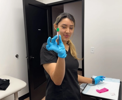 medical assistant student holding a vial in a classroom
