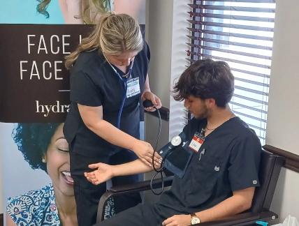 medical assistant students training to take patient's blood pressure