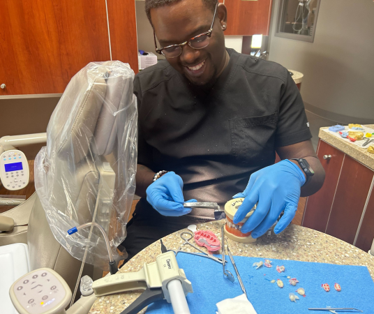 Dental Assistant in Shreveport dental office reviewing patient chart