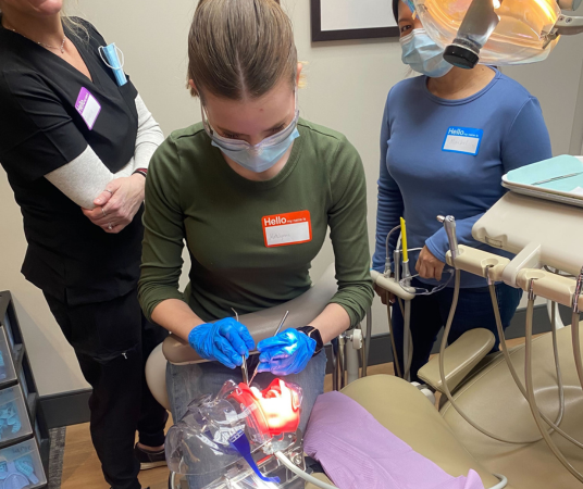 Dental Assistant in Oklahoma City dental office reviewing patient chart