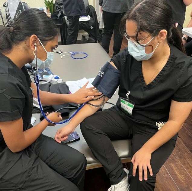 students training to take blood pressure counts